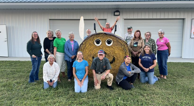 volunteers with decorated hay bail